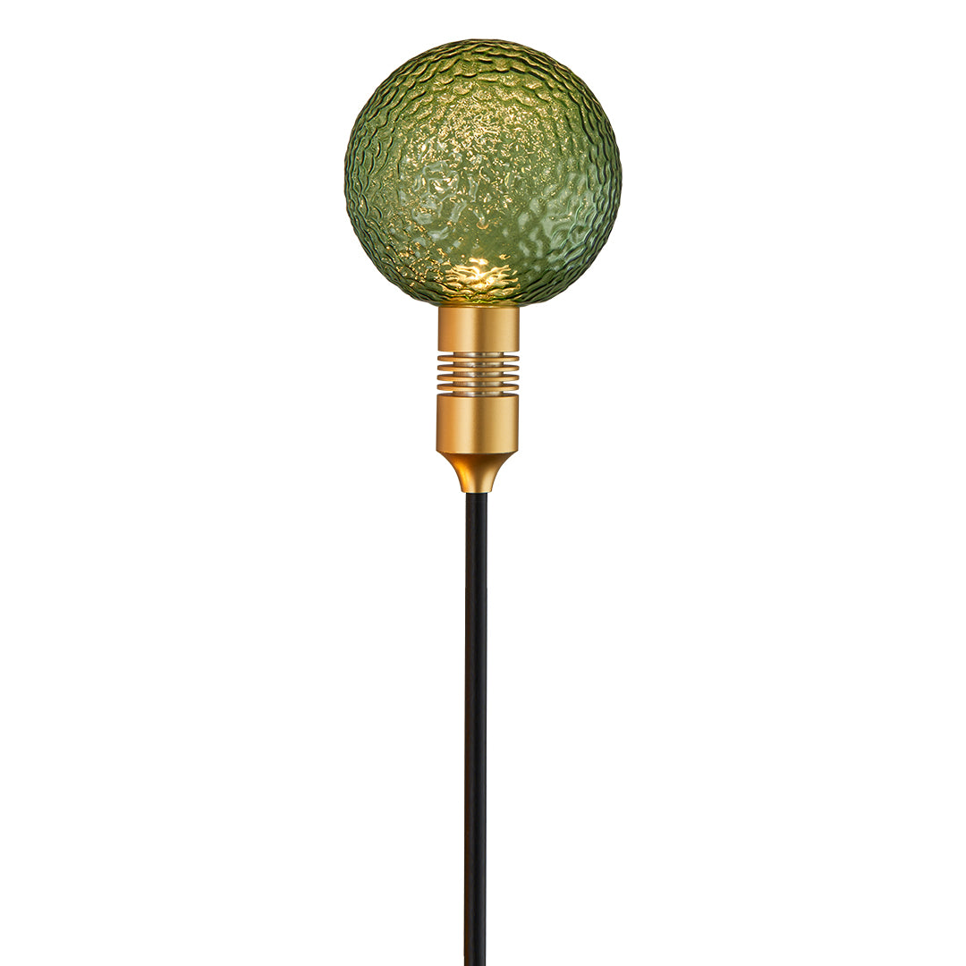 Deep green illuminated crackle-glass globe providing decorative path landscape lighting.