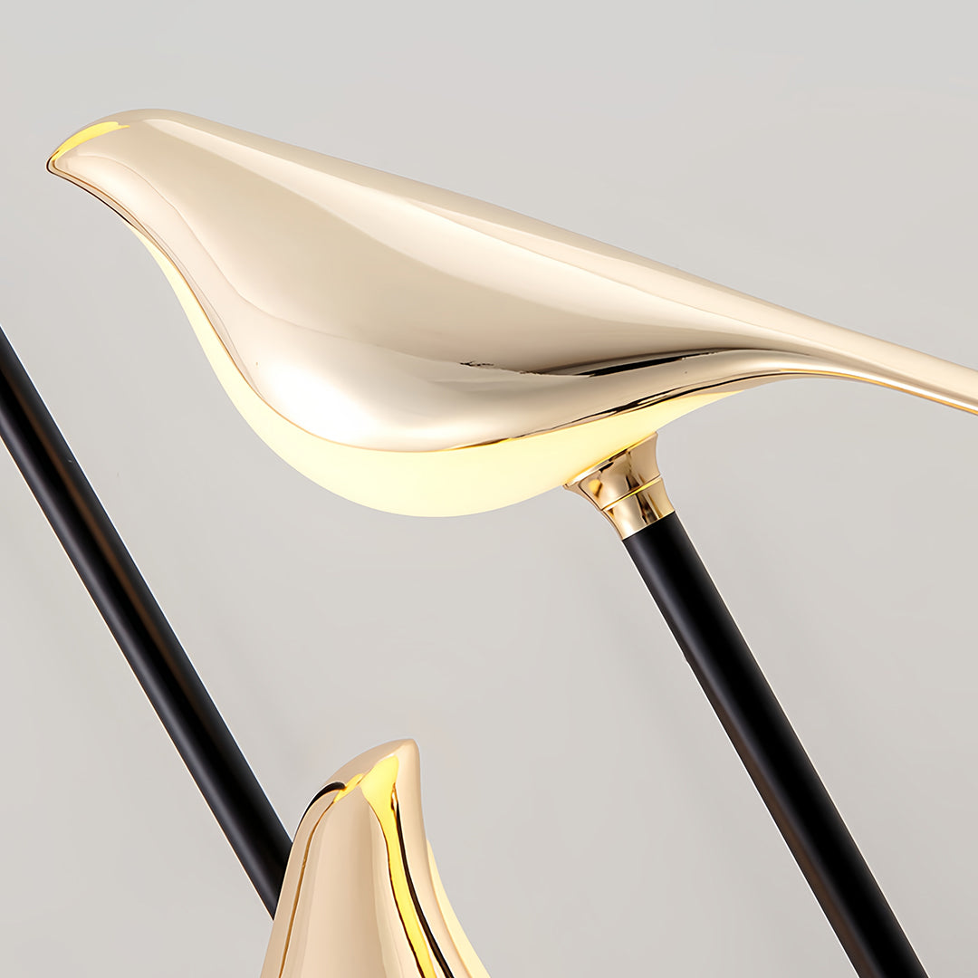 Designer bird floor lamp close-up revealing sleek bird silhouette design and modern metallic finish details
