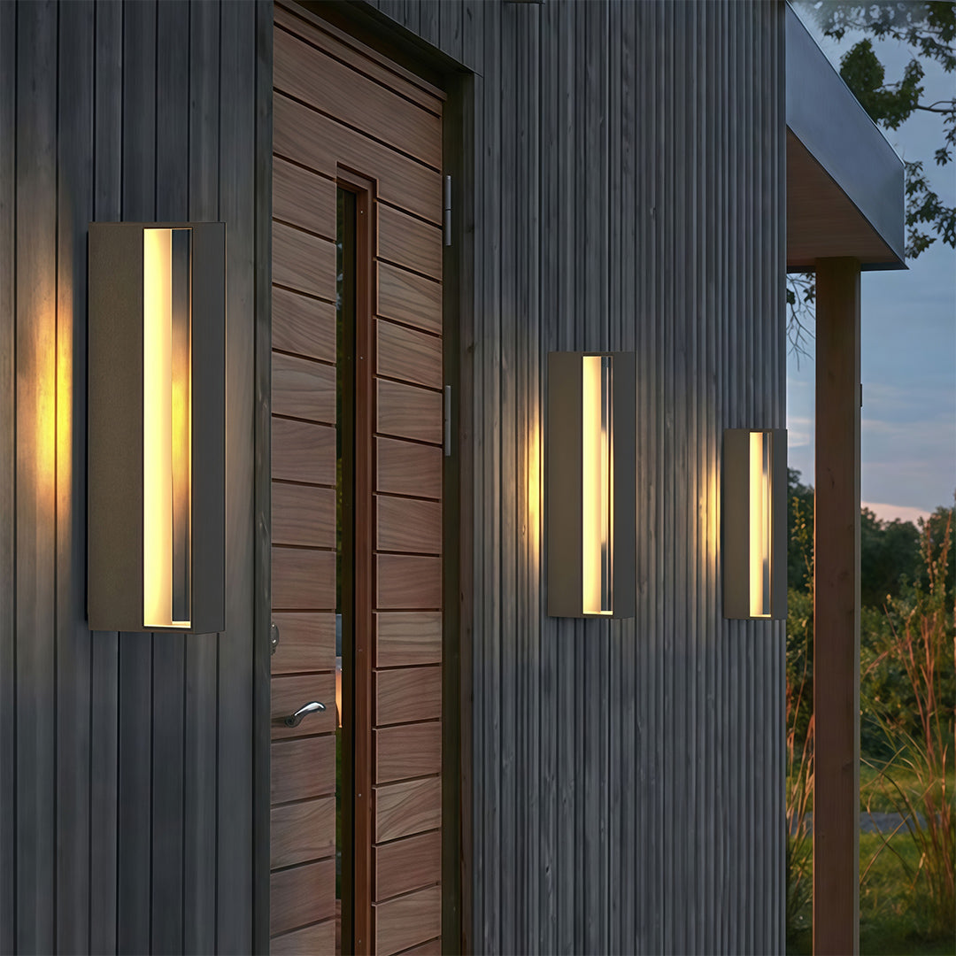 Designer black sconces outdoor featuring glass shade chandelier aesthetic in multiple arrangements illuminating contemporary wood-clad exterior.