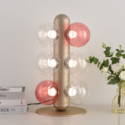 Designer bubble table lamp with coral and white glass orbs on minimalist desk setup