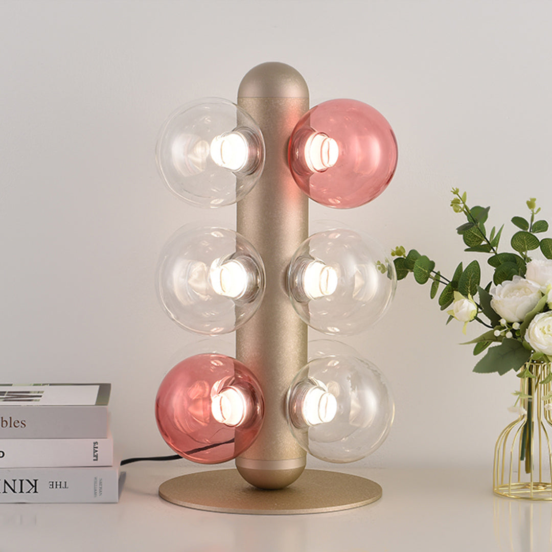 Designer bubble table lamp with coral and white glass orbs on minimalist desk setup