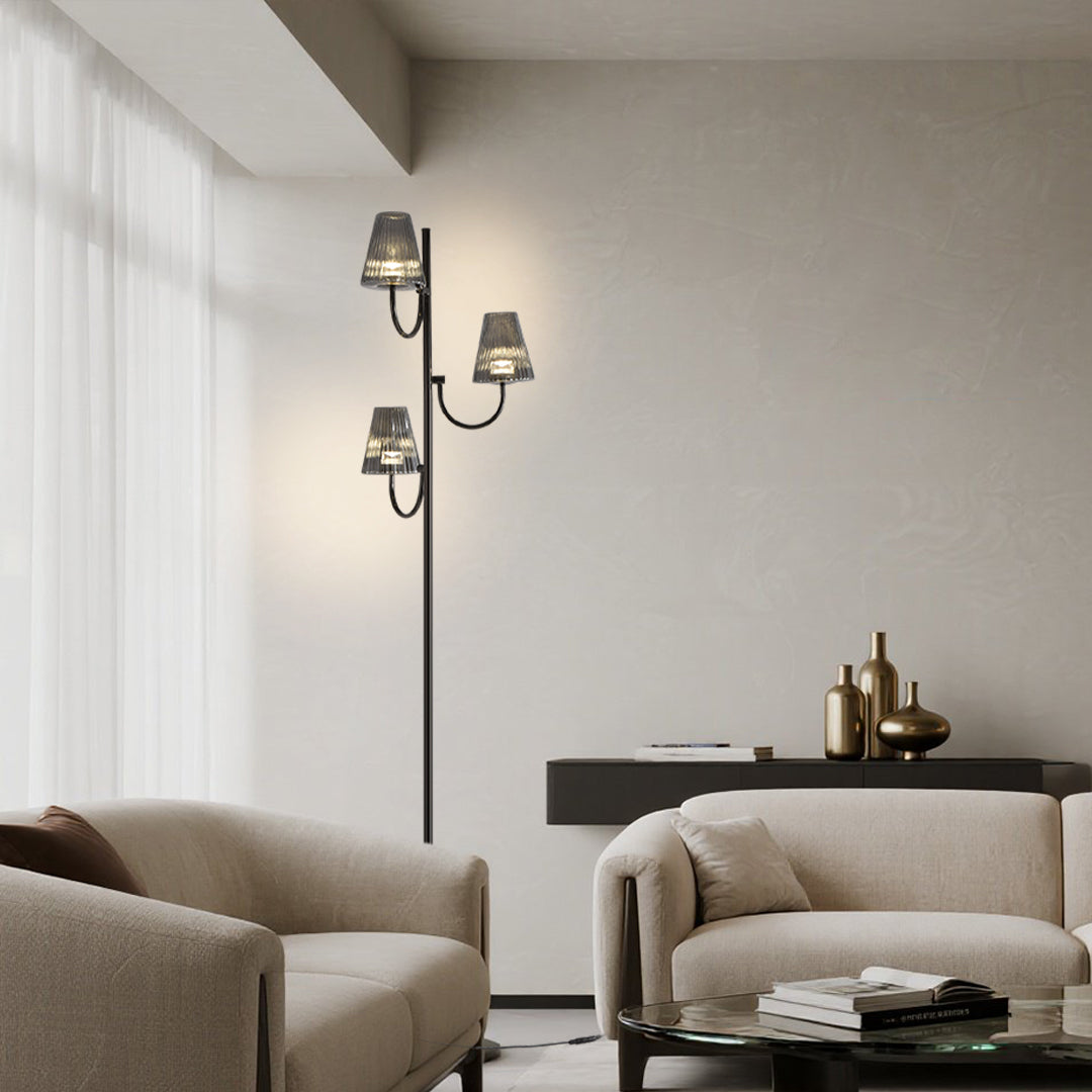 Designer floor lighting fixture illuminating contemporary seating area with warm atmospheric glow