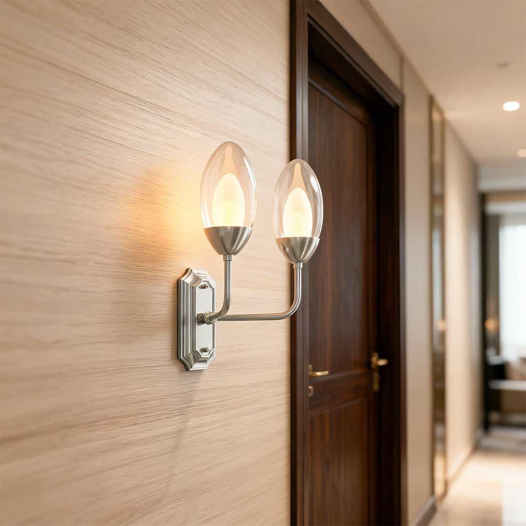 Designer glass wall light featuring glass shade chandelier aesthetic providing accent lighting in contemporary hallway.
