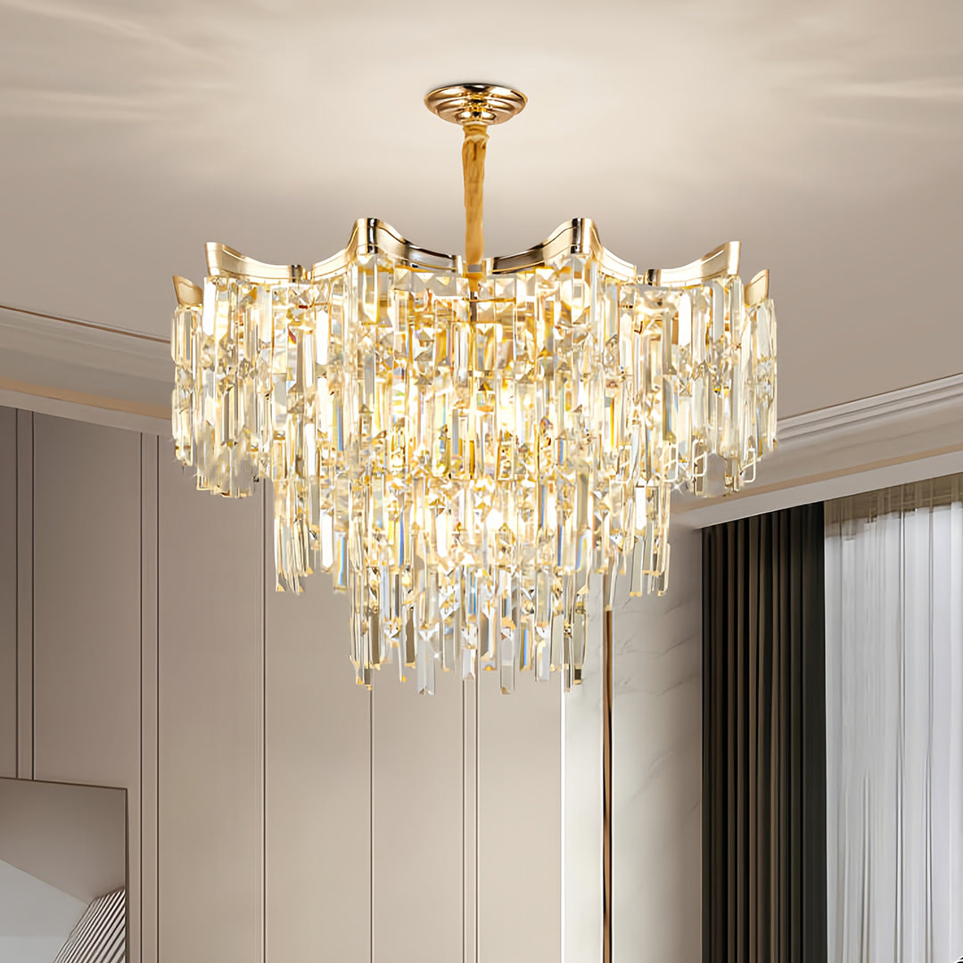 Designer tiered glass chandelier with warm gold finish creating ambient lighting in modern space