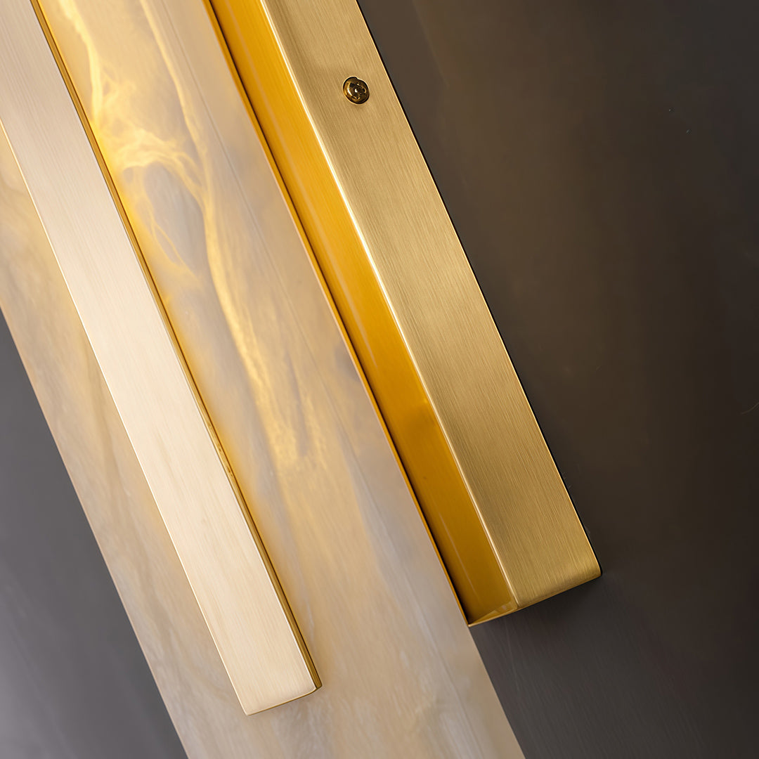 Designer gold wall light featuring glass shade chandelier aesthetic shown in detailed angled view highlighting gold and glass construction.