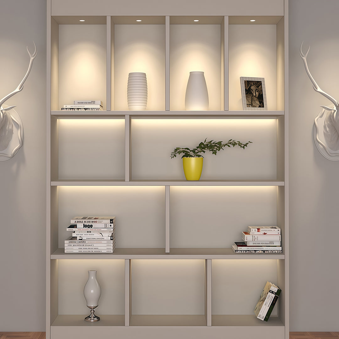 Designer indoor spotlights highlighting wall shelving unit with glass shade chandelier influenced warm ambient glow.