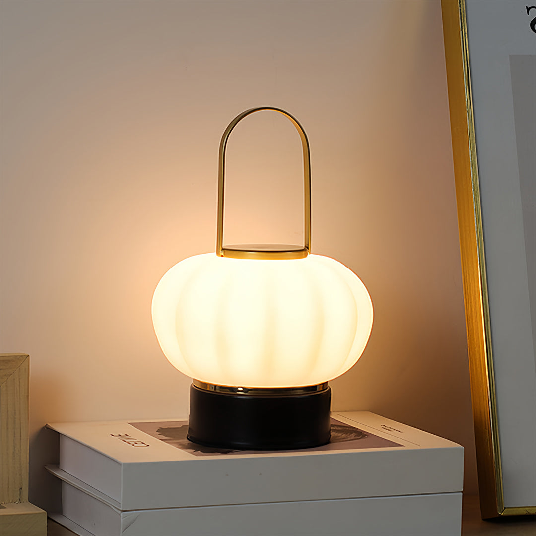 Designer lantern table lamp providing bedside lighting with warm glow and artistic appeal