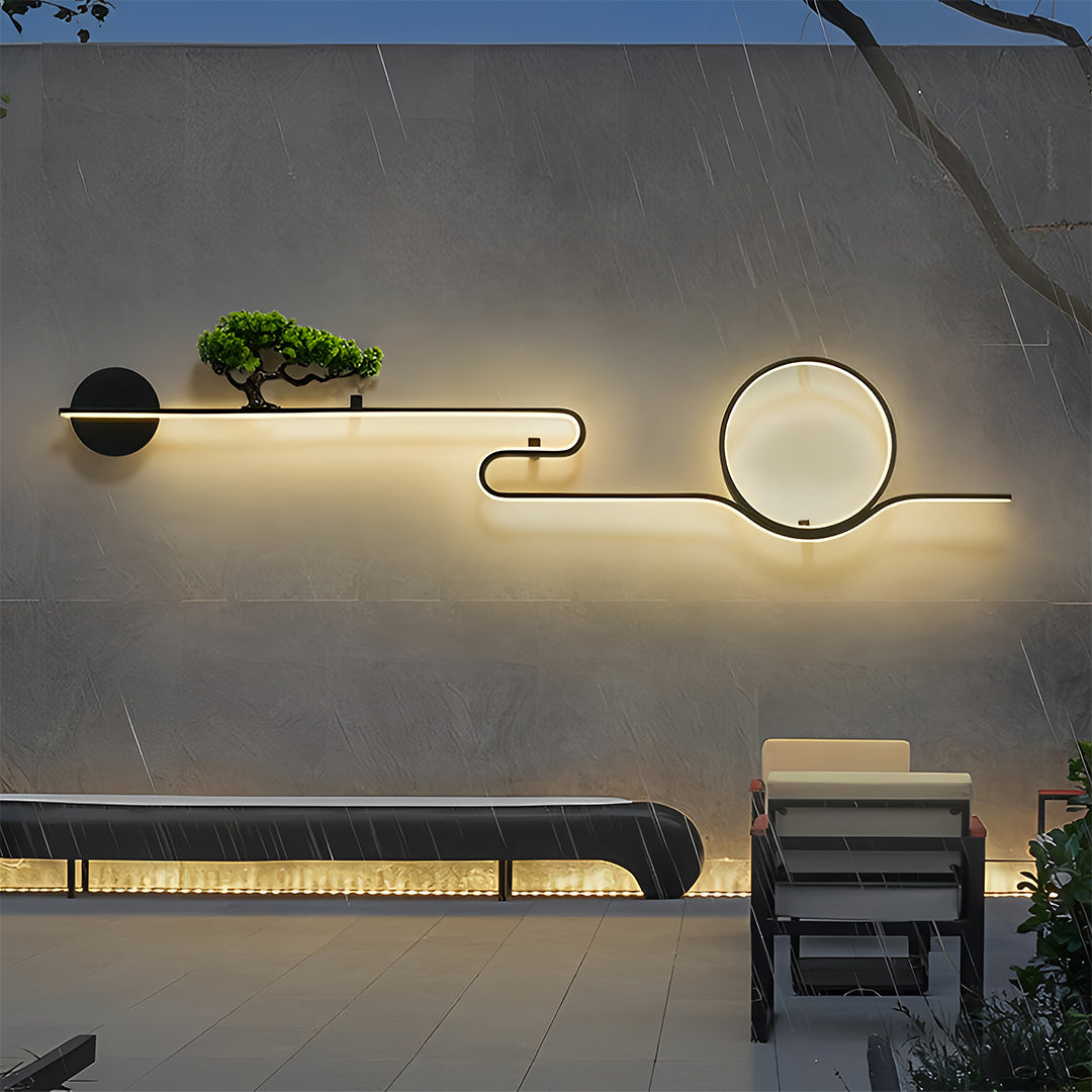 Designer outdoor wall lights with sculptural circular form on a modern patio wall.
