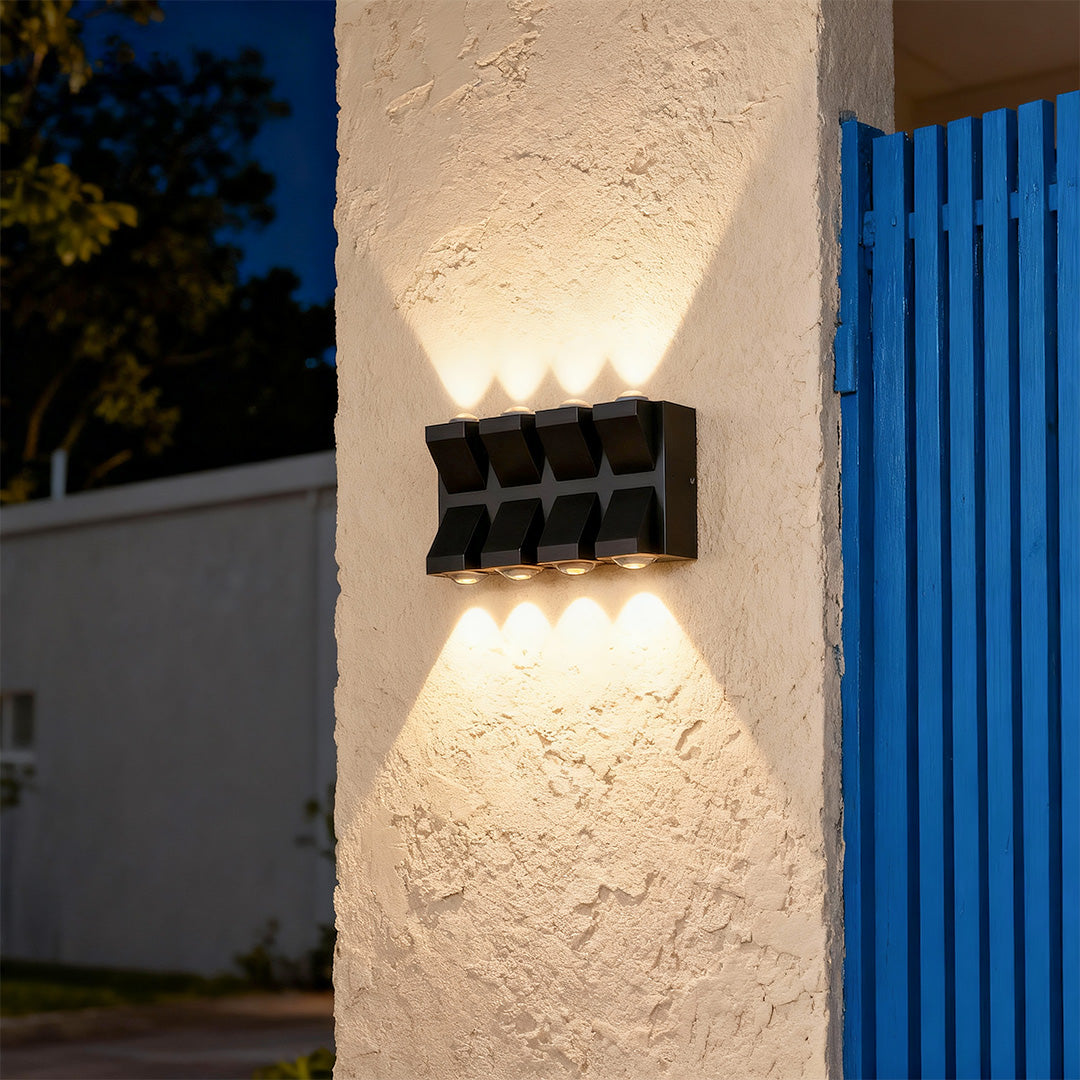 Designer outdoor wall lights black with glass shade chandelier aesthetic creating beautiful illumination on rough stone facade.