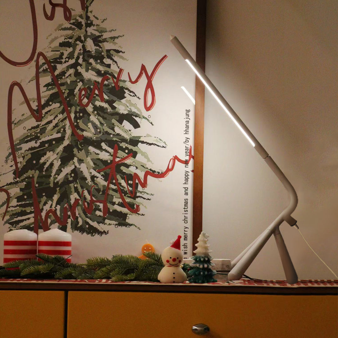 Designer three legged table lamp with plant decor creating stylish modern interior accent lighting