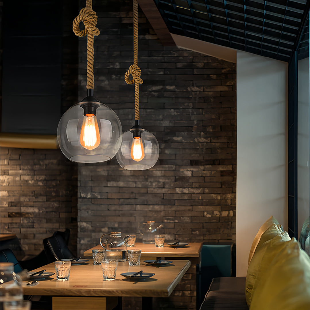 Designer retro glass pendant lights creating sophisticated lighting scheme in upscale restaurant.