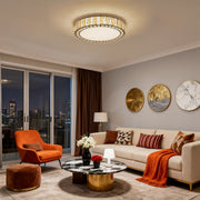 Designer round LED flush mounted ceiling lights featuring glass shade chandelier influence in elegant living room with city views.
