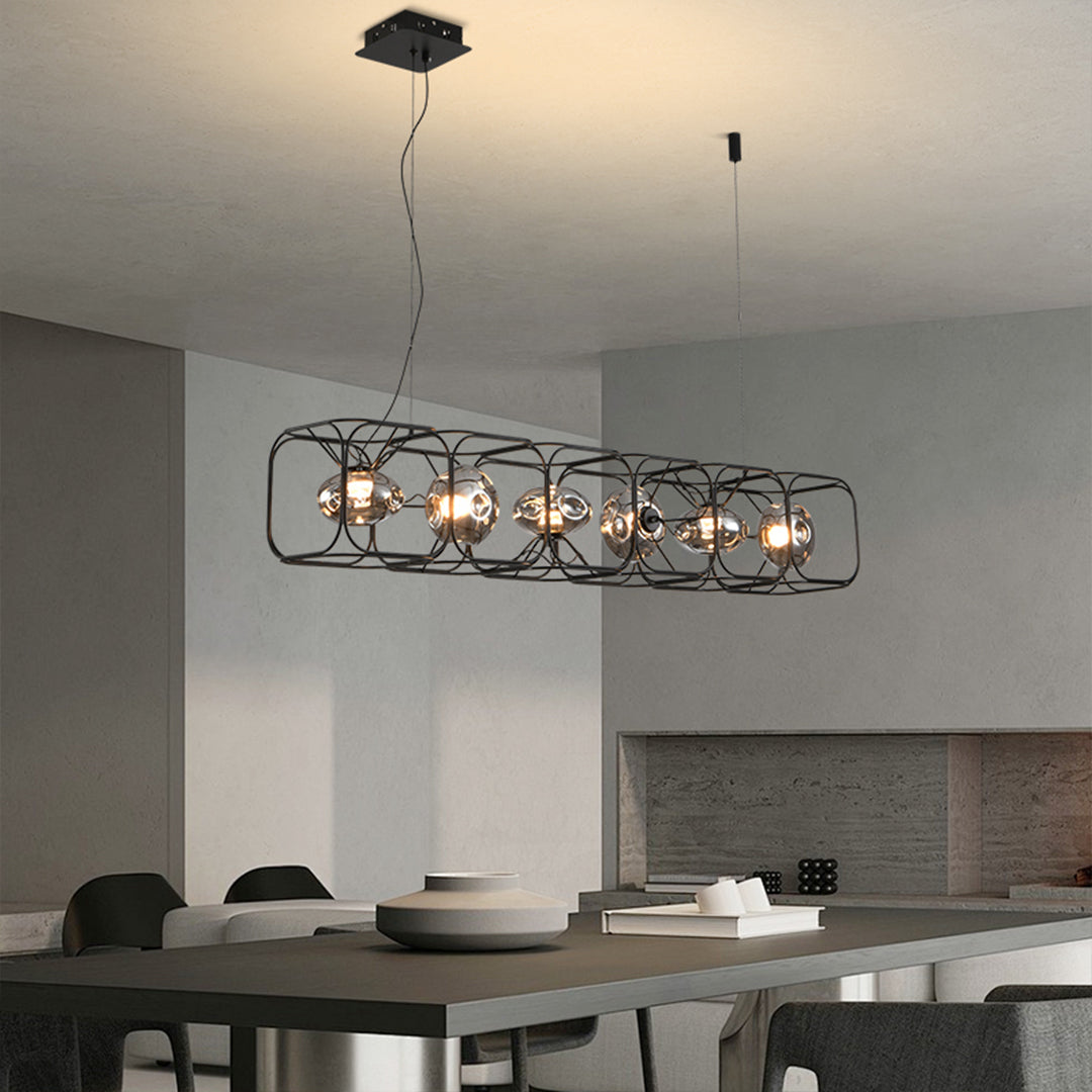 Designer square cage chandelier suspended over modern dining table in contemporary gray interior space
