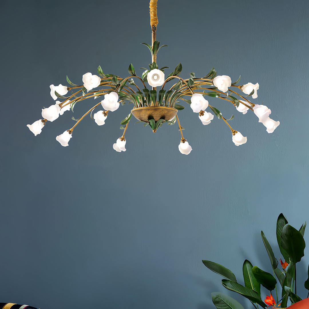 Designer vintage floral chandelier with blue chair accent creating sophisticated eclectic interior design