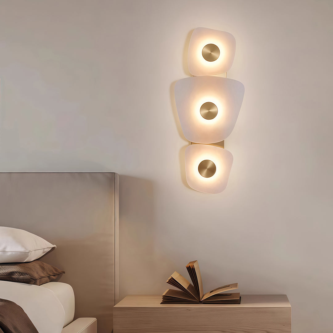 Designer wall art lighted featuring glass shade chandelier aesthetic creating warm ambient glow in modern neutral-toned bedroom.