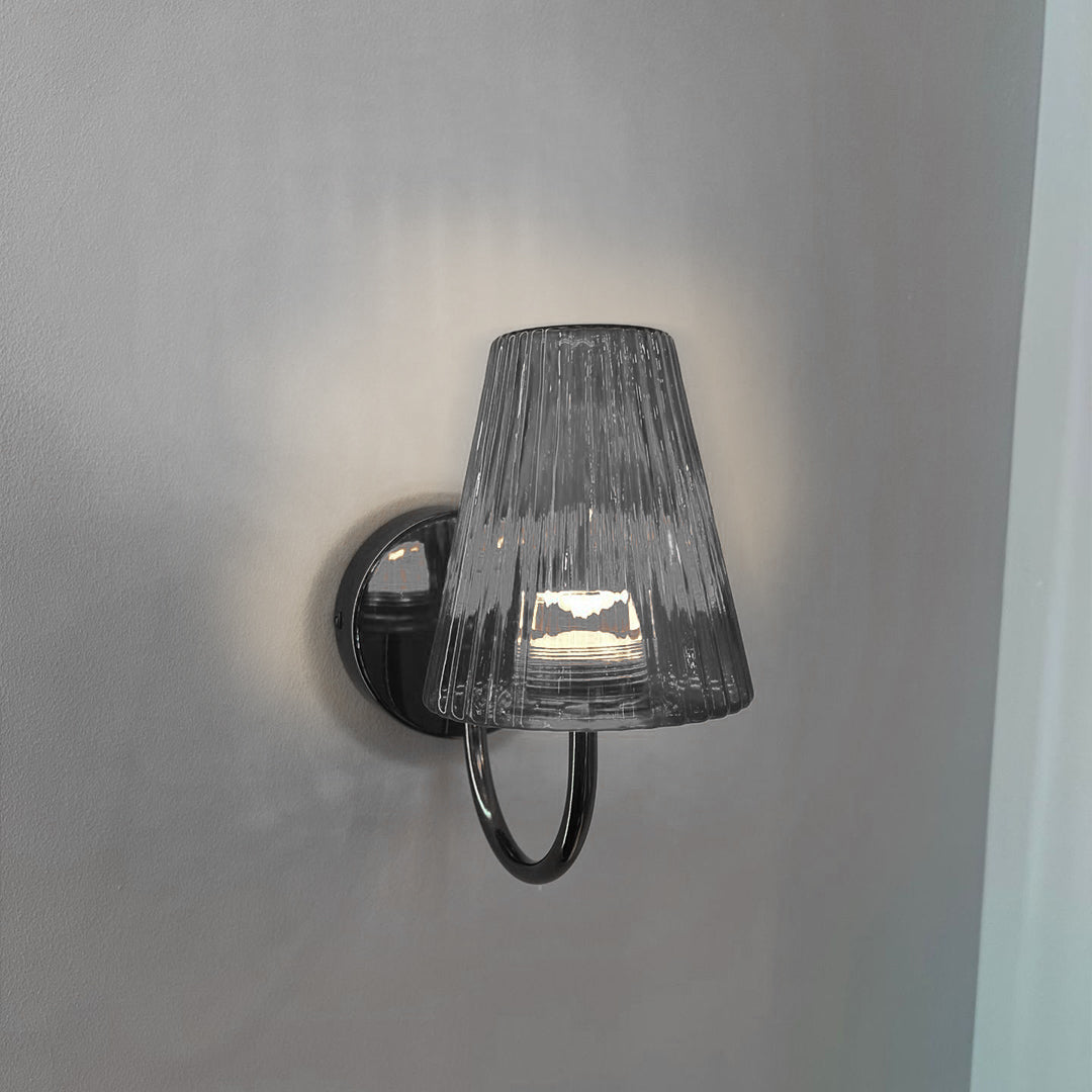 Designer wall light with textured shade creating sophisticated accent lighting in modern interior