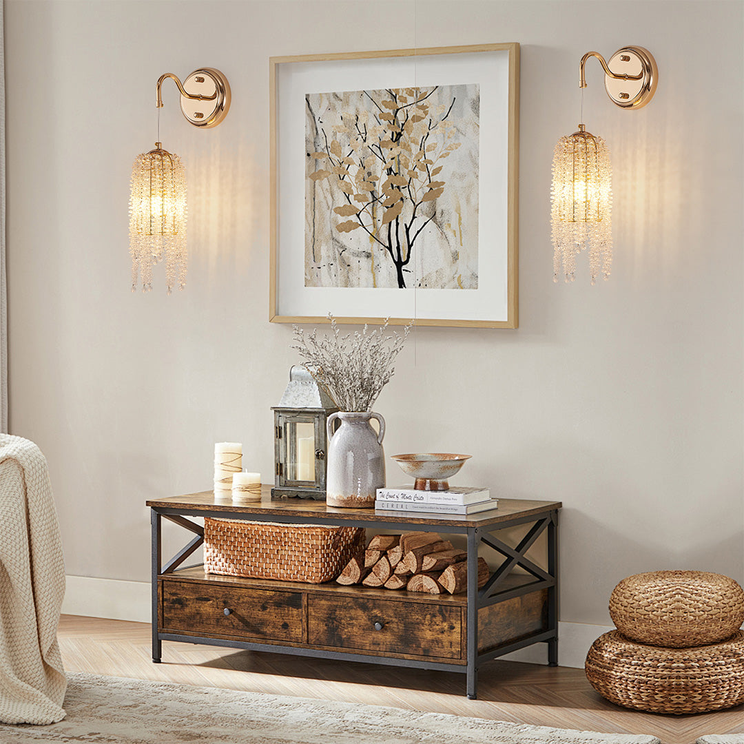 Designer wall lights with crystals and glass shade chandelier design flanking artwork above gold-accented console in elegant entryway.