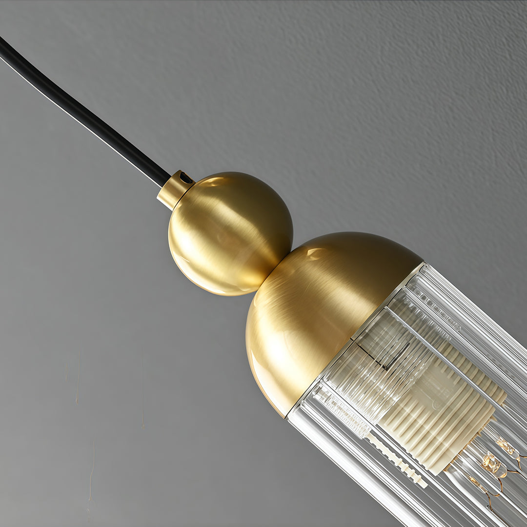 Designer wall mount pendant light featuring glass shade chandelier aesthetic shown in detailed close-up highlighting brass sphere joint.