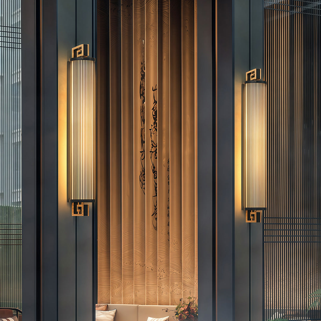 Designer wall mounted linear lighting featuring glass shade chandelier aesthetic creating ambient lighting on contemporary patio at dusk.