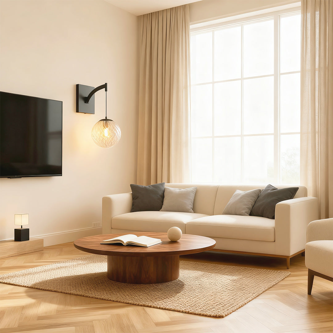 Designer wall mounted pendant light featuring glass shade chandelier aesthetic providing accent lighting in contemporary living room.