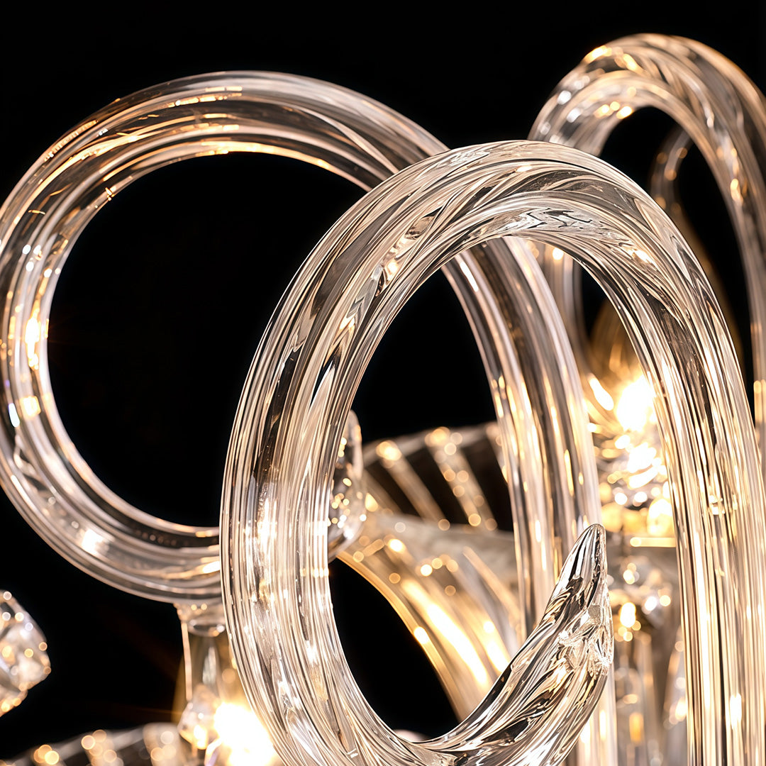 Detail view of art glass chandelier arm featuring intricate crystal work and champagne gold finish.