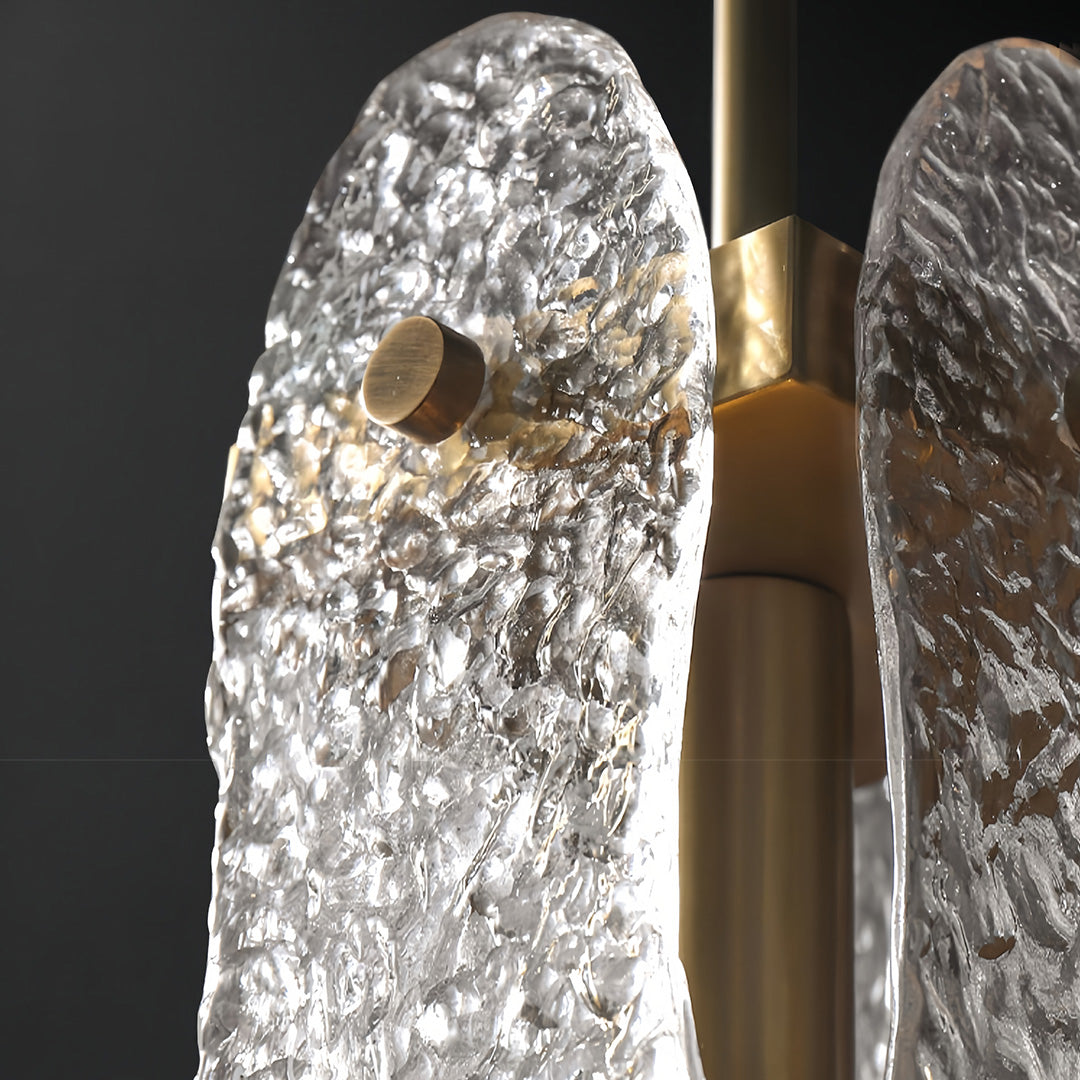 Detail view of brass glass pendant light revealing organic texture pattern and brushed metal finish.