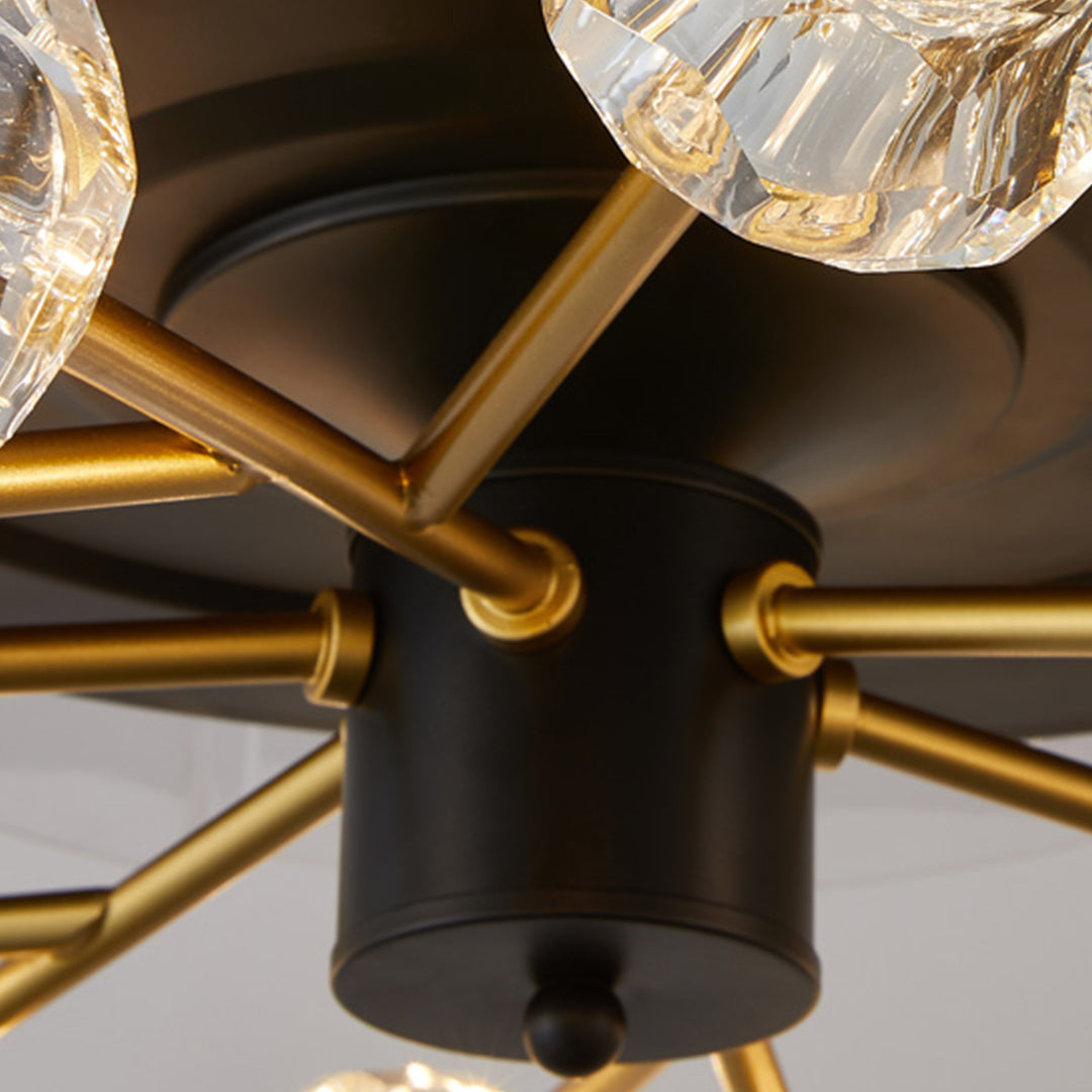 Detail view of gold ceiling fan arm with crystal light fixture and transparent retractable blade attachment