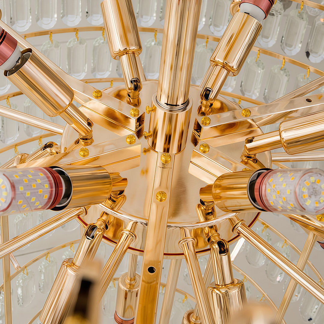 Detail view of large gold chandelier center revealing radiating gold arms and crystal arrangement.