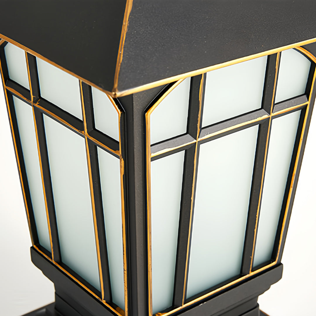 Close-up detail of large outdoor pillar lights featuring textured frosted panels and gold trim.