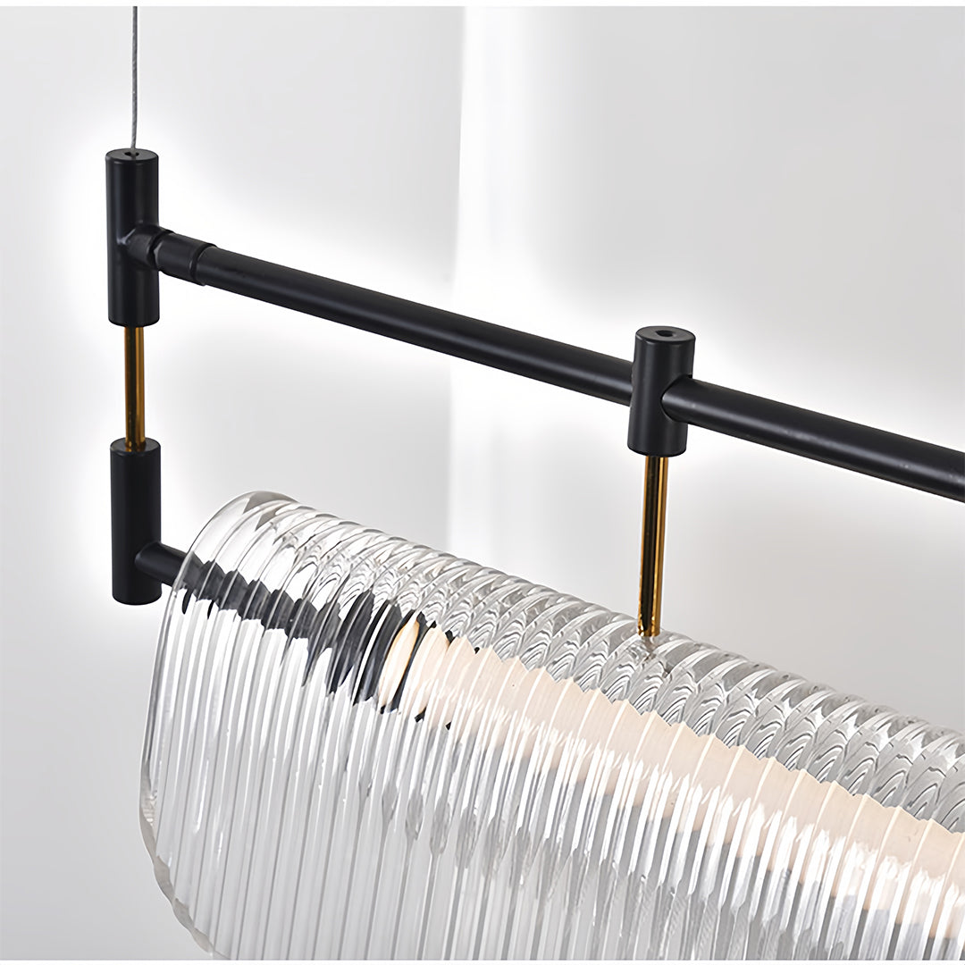 Detail shot of linear light pendant revealing layered glass construction and matte black hardware.