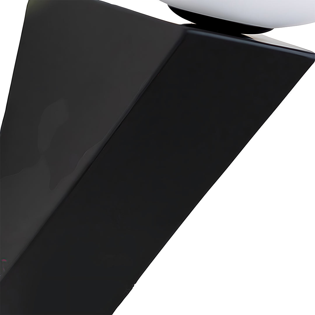 Detailed shot of the angled black metal bracket supporting the globe wall light, showing the geometric design.