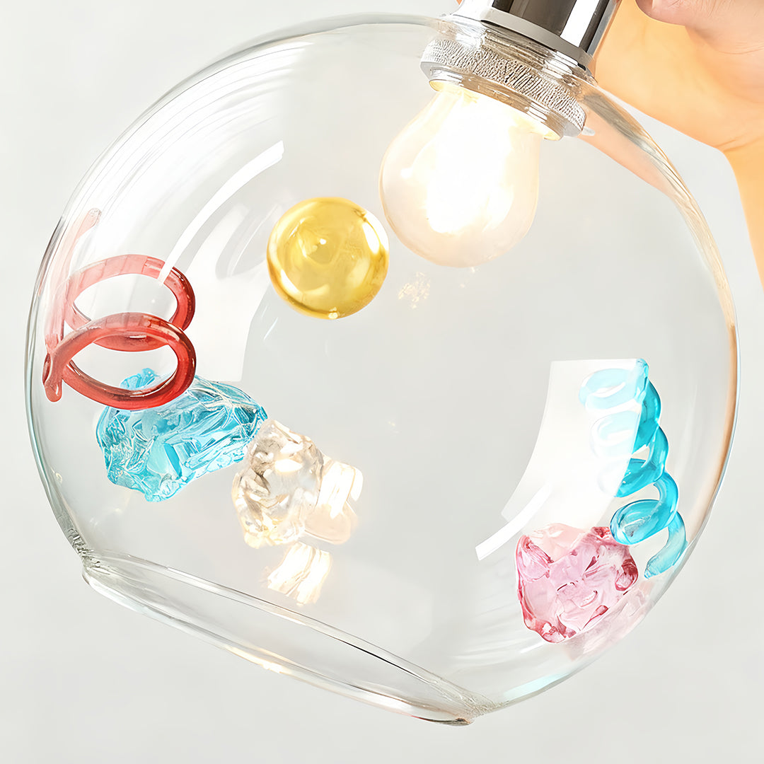Detailed close-up of coloured glass pendant lights highlighting gold disc and red/blue swirl internal decoration.