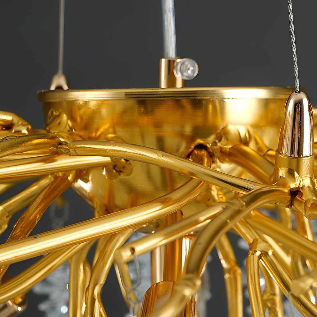 Detailed close-up of intricate gold tree branches on a modern gold crystal chandelier frame.