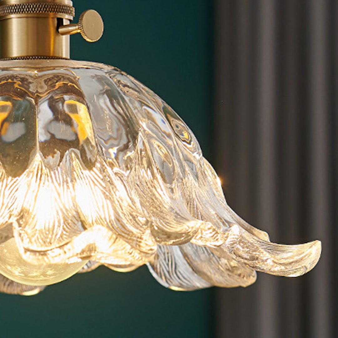 Close up detail of flower pendant lighting showing intricate glass texturing and warm LED lighting.