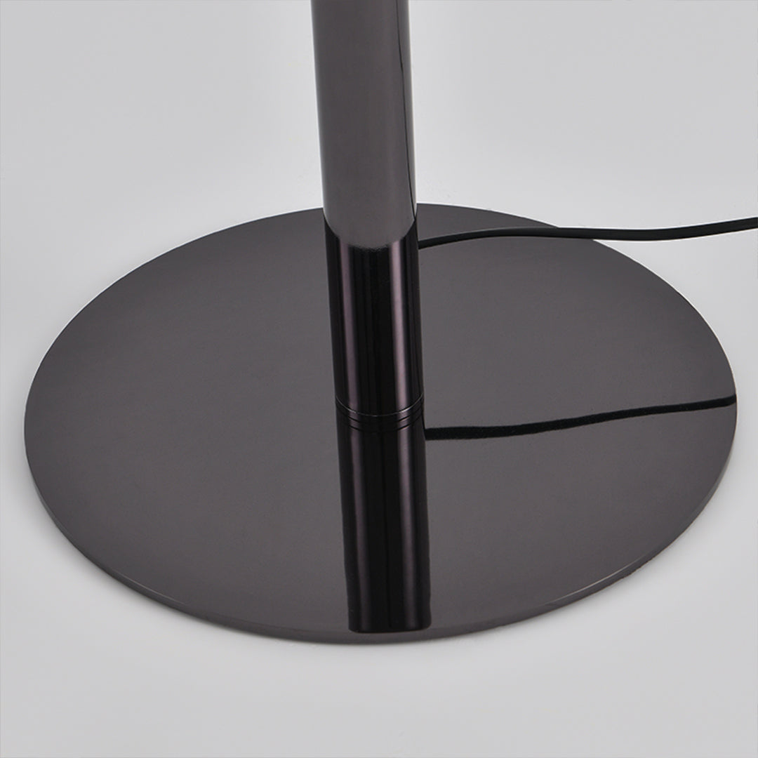 Detailed view of art table lamp base showing matte black circular foundation design