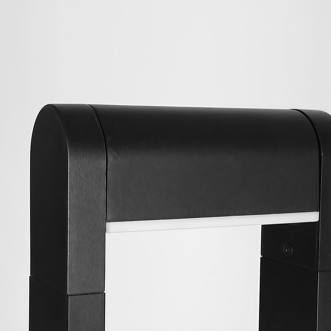 Detailed view of the base of a pathway bollard light, emphasizing the sturdy black structure.
