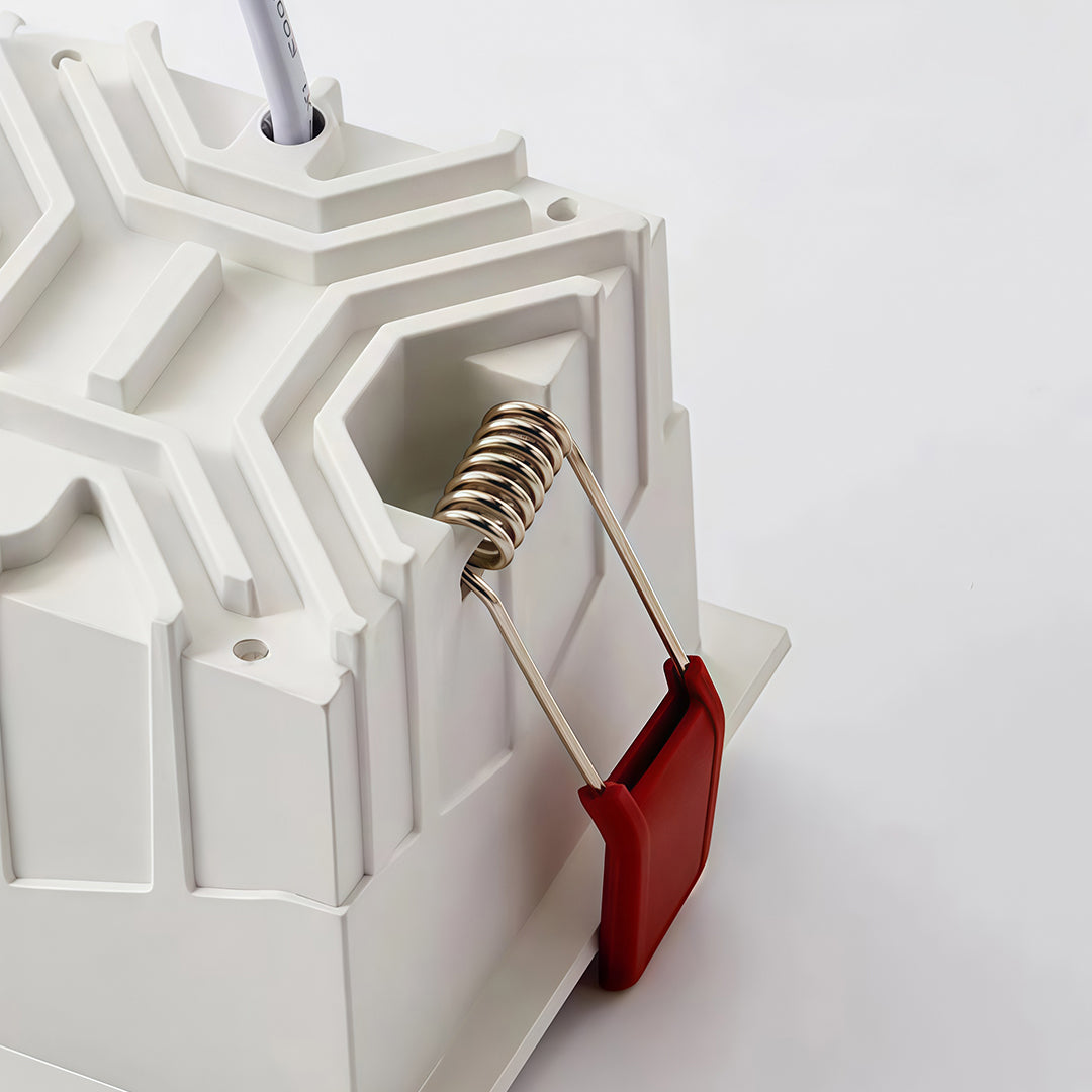 Detailed rear view of a white square led downlights fixture showing the spring clips for installation.