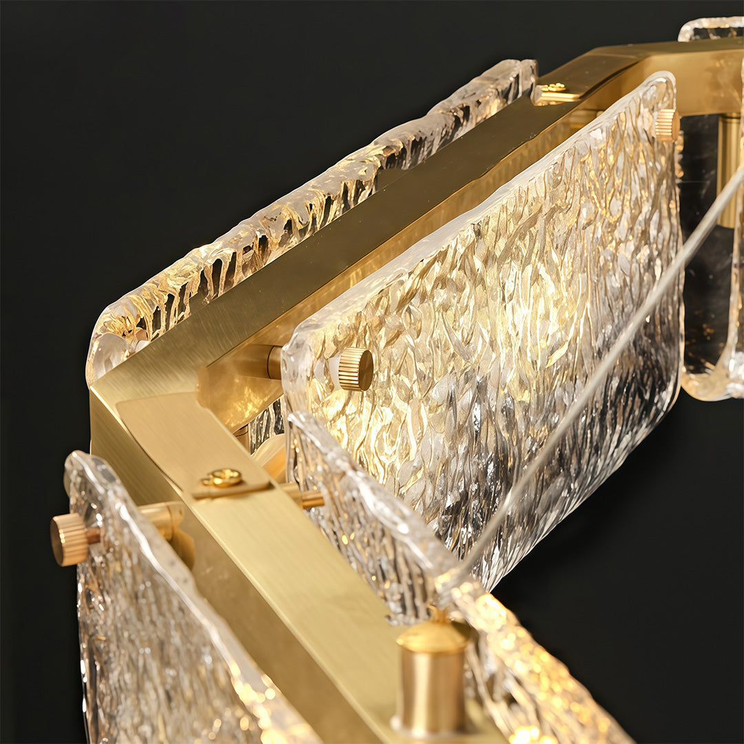 Detailed view of a rectangular glass chandelier, showcasing the intricate glass texture and gold accents.