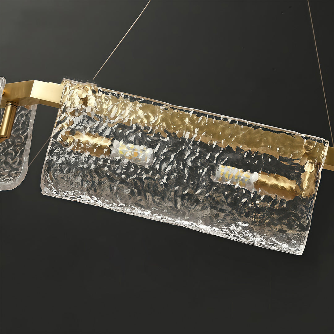 Detailed view of a rectangular glass chandelier, showcasing the intricate glass texture and gold accents.