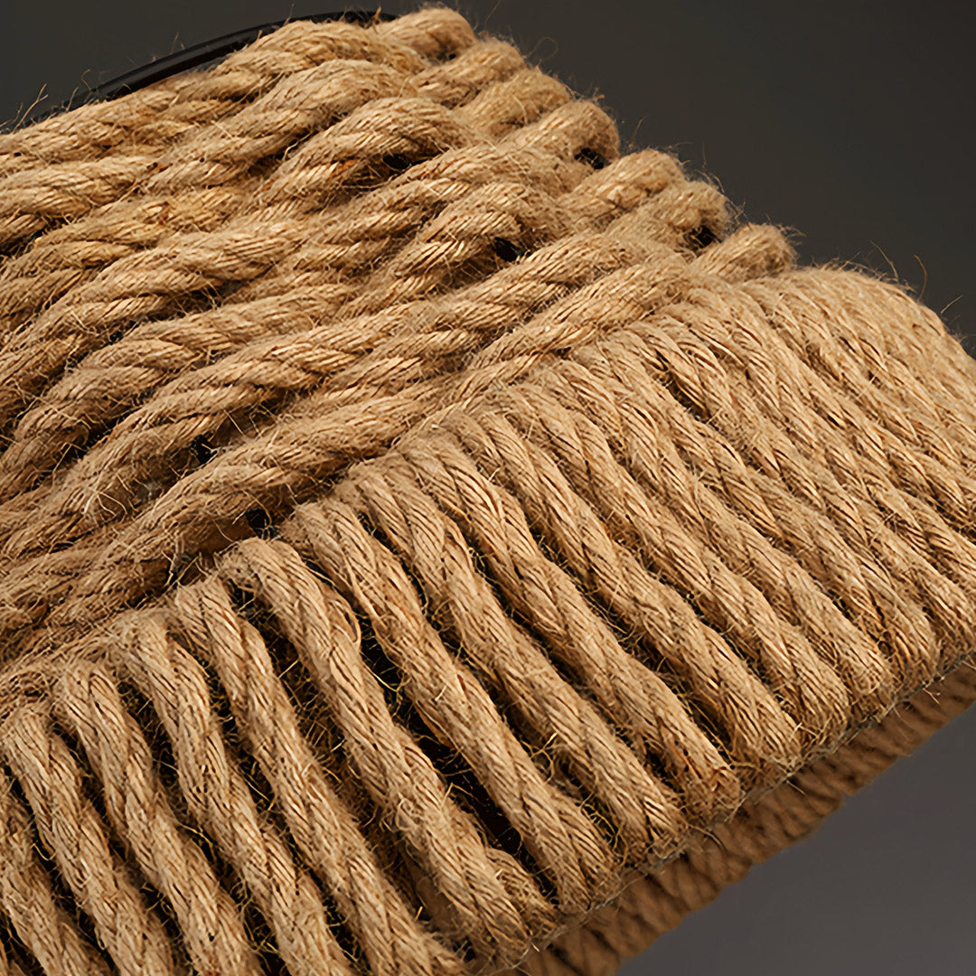 Detailed texture shot of the natural jute rope pendant lights showing the tightly bound lower edge of the shade.