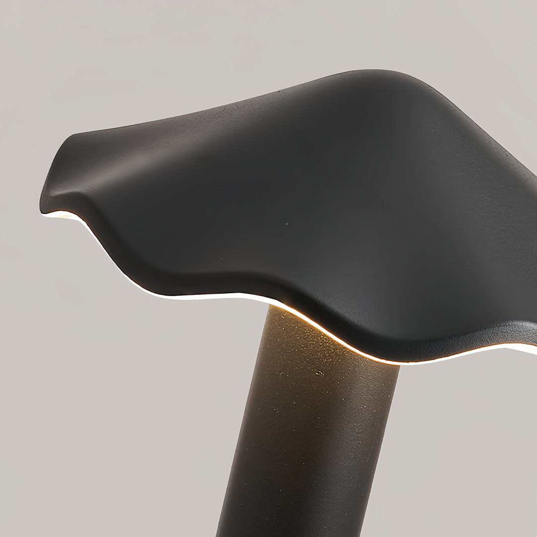 Detailed top view of the black matte finish and wave-edge design of the metal pathway lights head.