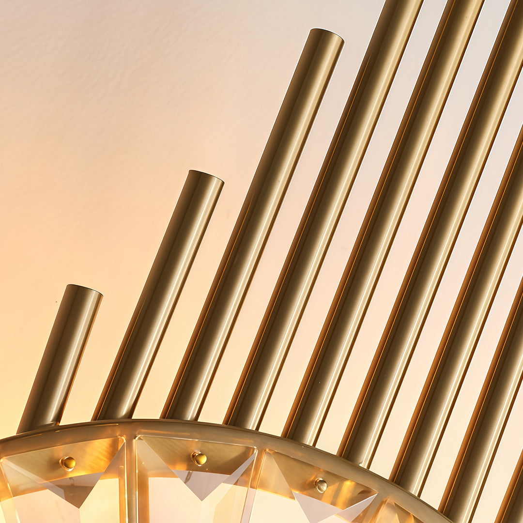 Detailed view of crystal light wall with glass shade chandelier design showing radiating gold tubes and illuminated central crystal element.