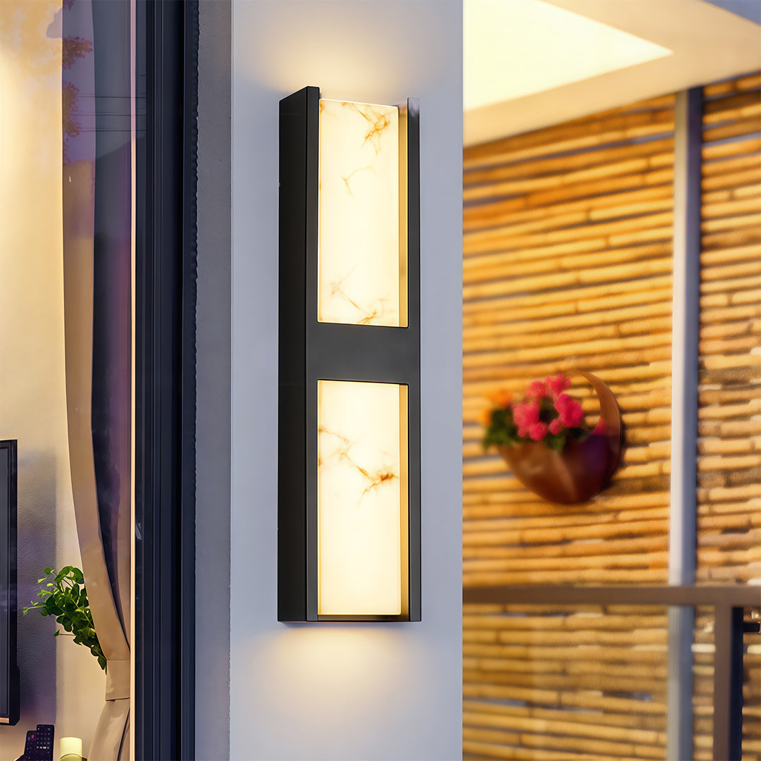 Detailed view of LED wall sconce light fixtures featuring glass shade chandelier aesthetic showing black textured construction detail.