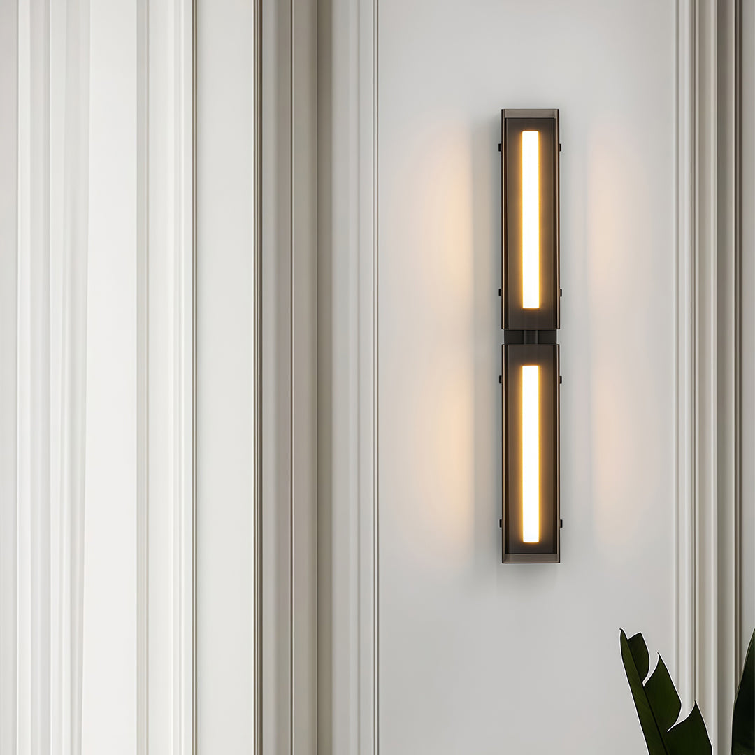 Detailed view of a modern wall light decoration, showcasing the black and gold finish and structure.