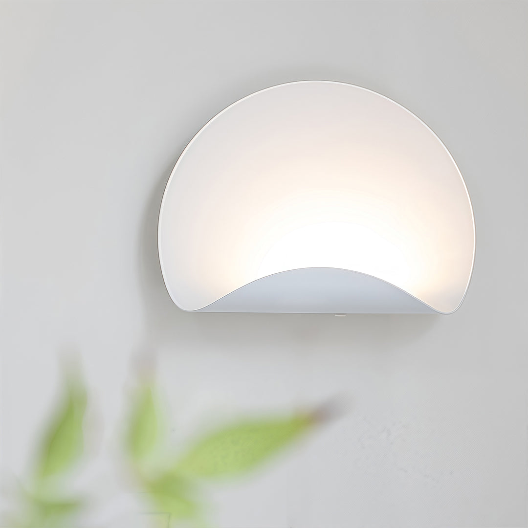 Detailed view of the white wall lights installed in a domestic setting, with a subtle glow around the base.