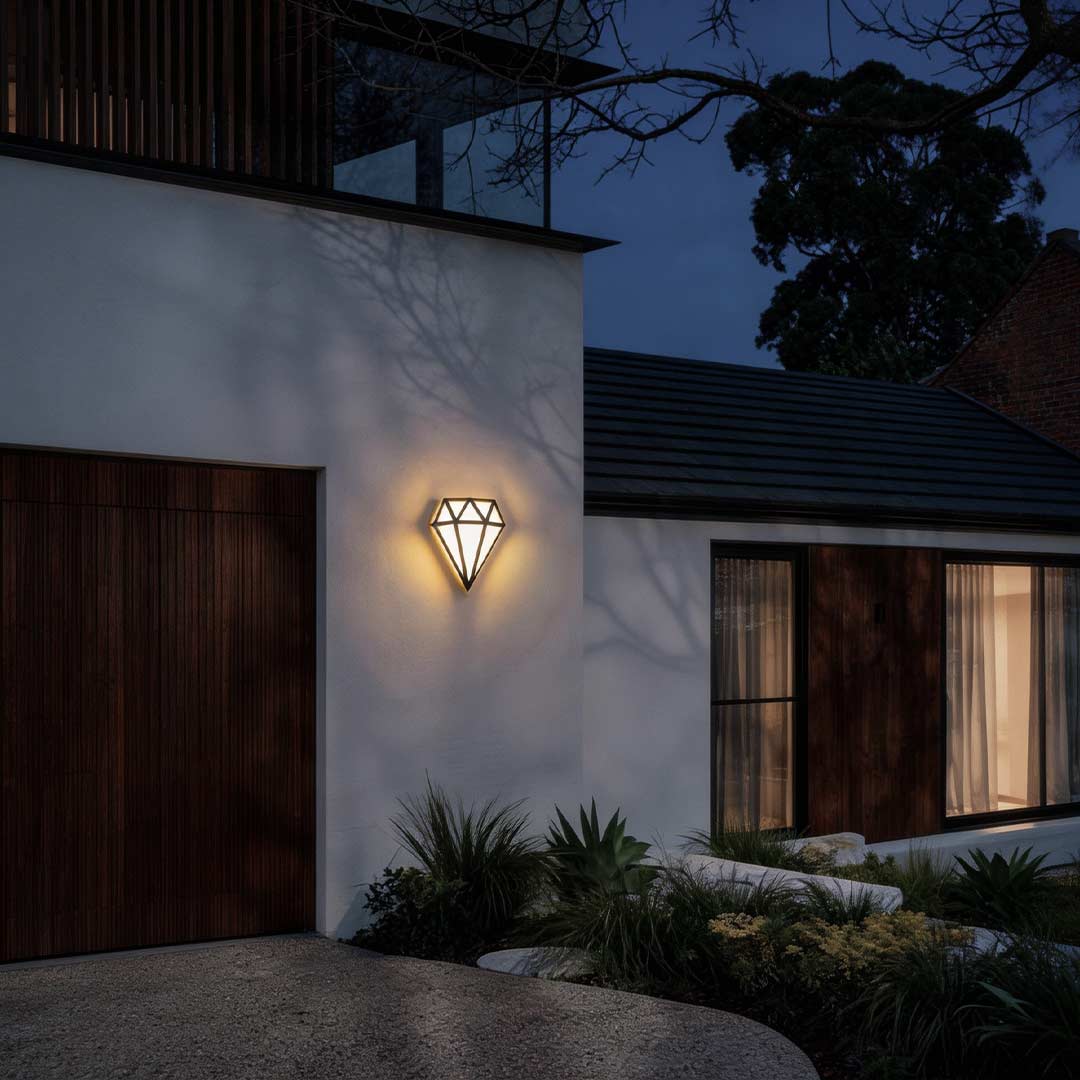 Diamond shape wall light illuminating a contemporary house entrance at dusk.