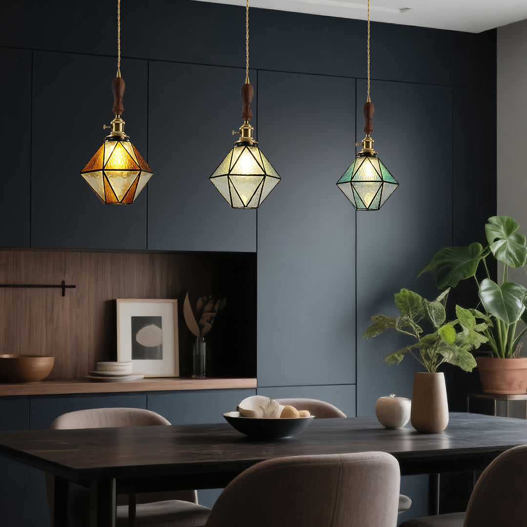 Diamond-shaped pendant lights over modern dining table with navy walls and sophisticated interior design elements