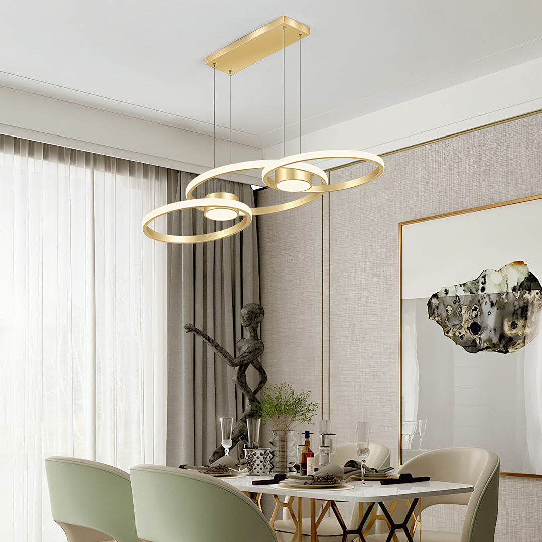 Sophisticated gold chandelier lamp above a dining area, contemporary ceiling light fixture