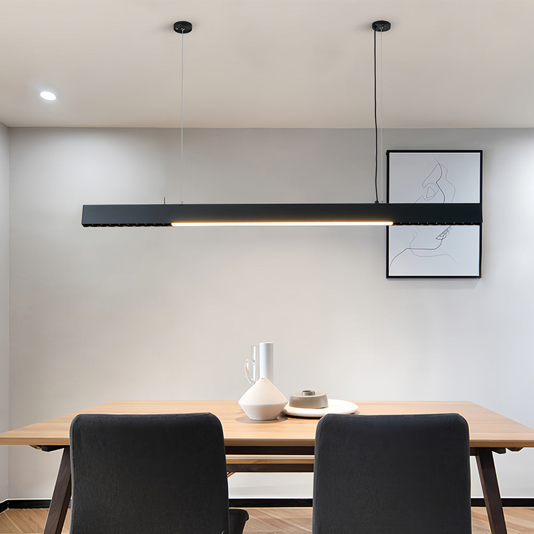 Dining area featuring white linear light pendant with minimalist design and warm lighting