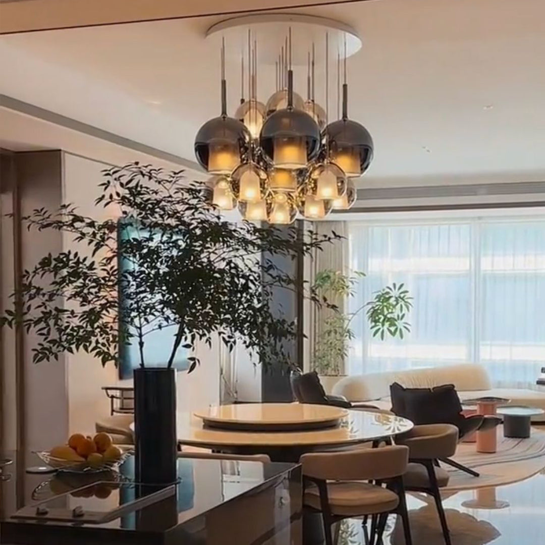 Luxury dining room with bronze and amber glass ball pendant lights creating warm atmospheric lighting